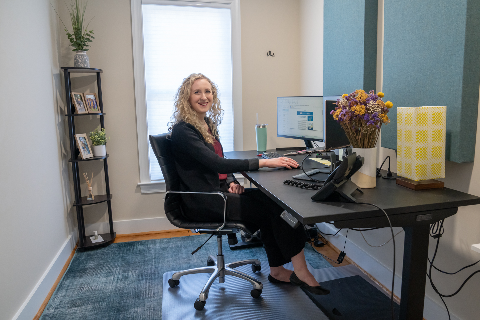 Sara Kate Garman, CPA sitting at her desk reading about Roth IRAs.