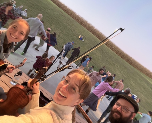 K 3 Kaley with her fiddle on a stage